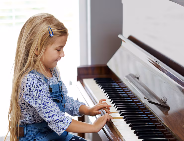 children learning how to play the piano